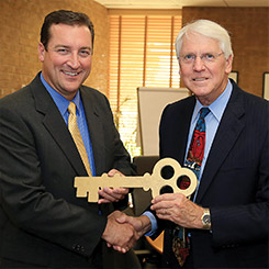 Alan Goben receives the key to campus from Larry Darlege