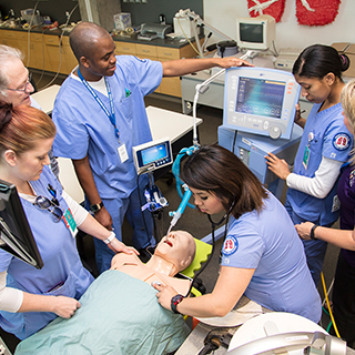 Respiratory care students practice on a mannequin