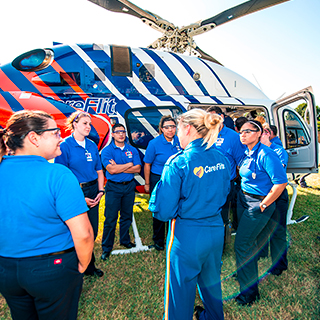 EMT students gathered around a helicopter